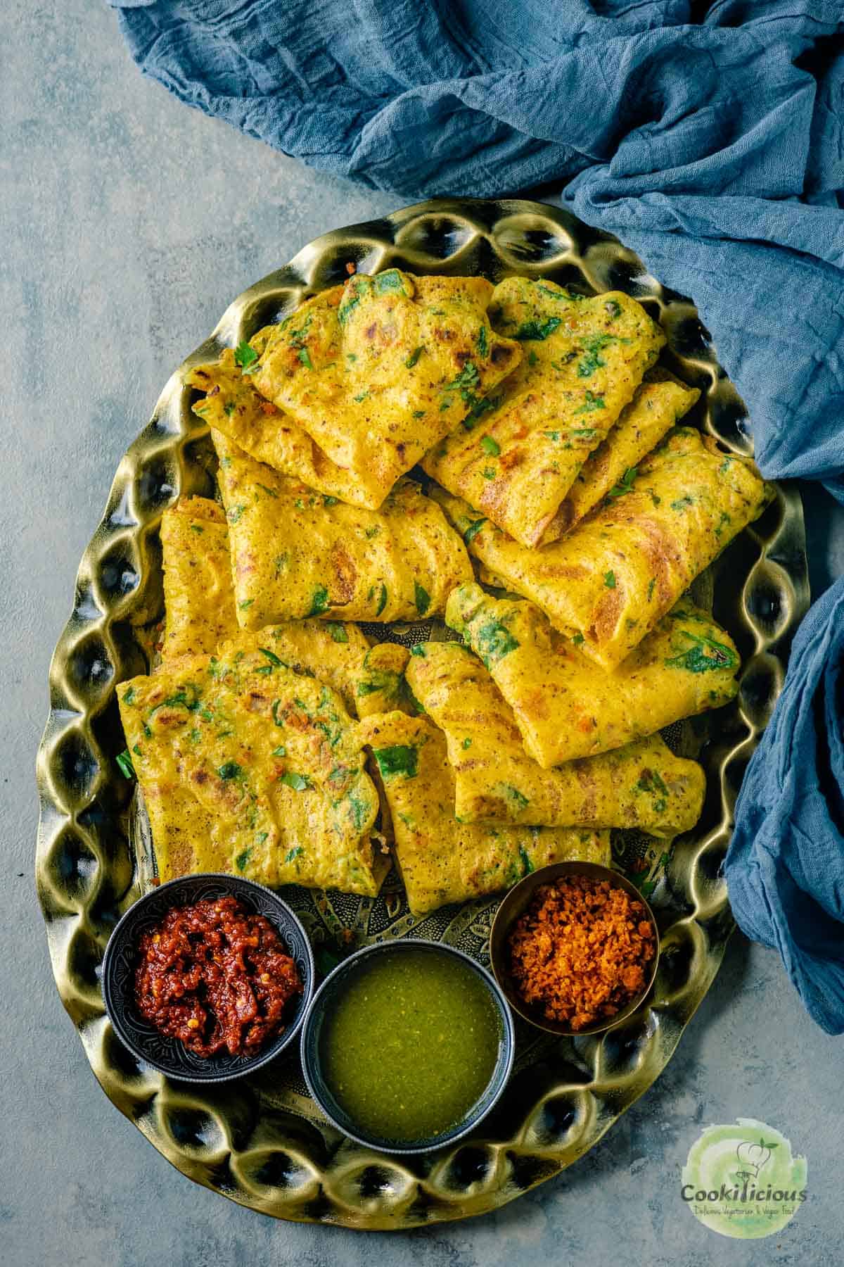 a large oval tray filled with Moong Dal Chillas.