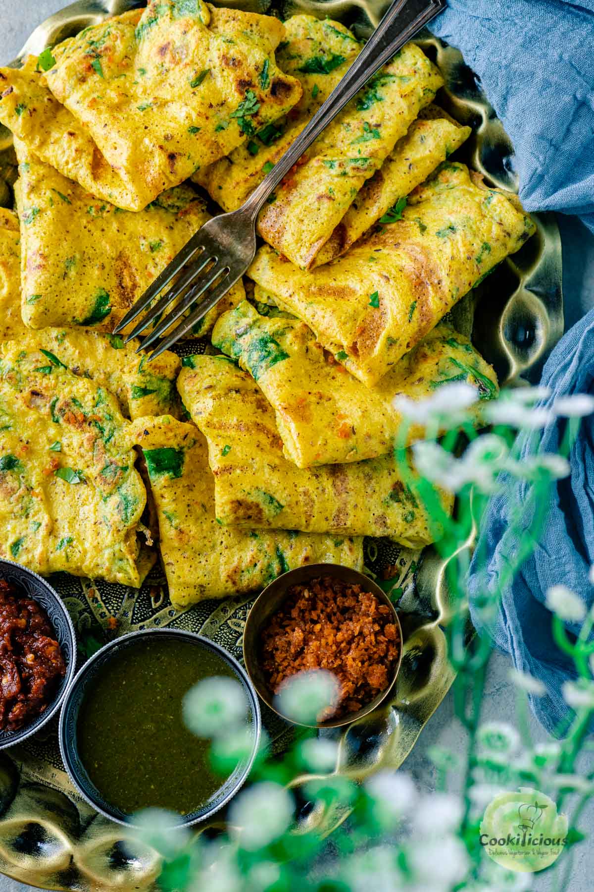 Moong Dal Chilla placed on a plate with a fork on top